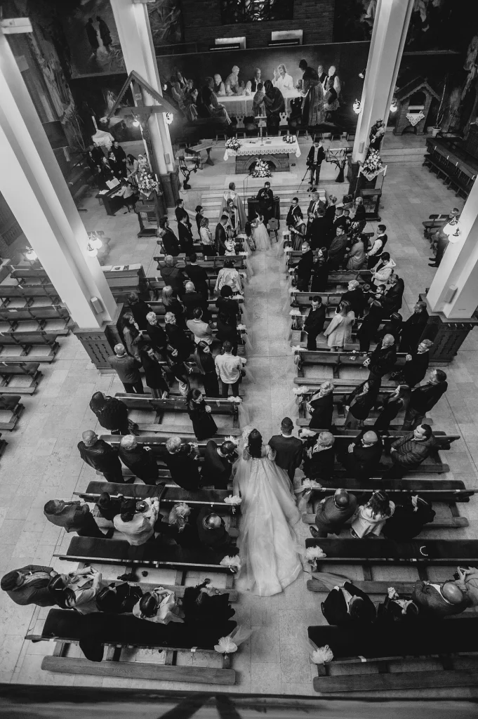 Bride walking down the aisle towards the altar in St. Stephen’s Cathedral in Vienna to say 'I do.' The image captures the grandeur and elegance of the iconic cathedral setting."