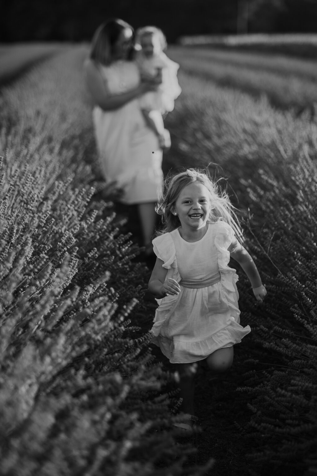 Tender moments between a mom and her baby in a lavender field in Vienna. The image captures the affectionate bond and serene beauty of the lavender field during the best time of day.
