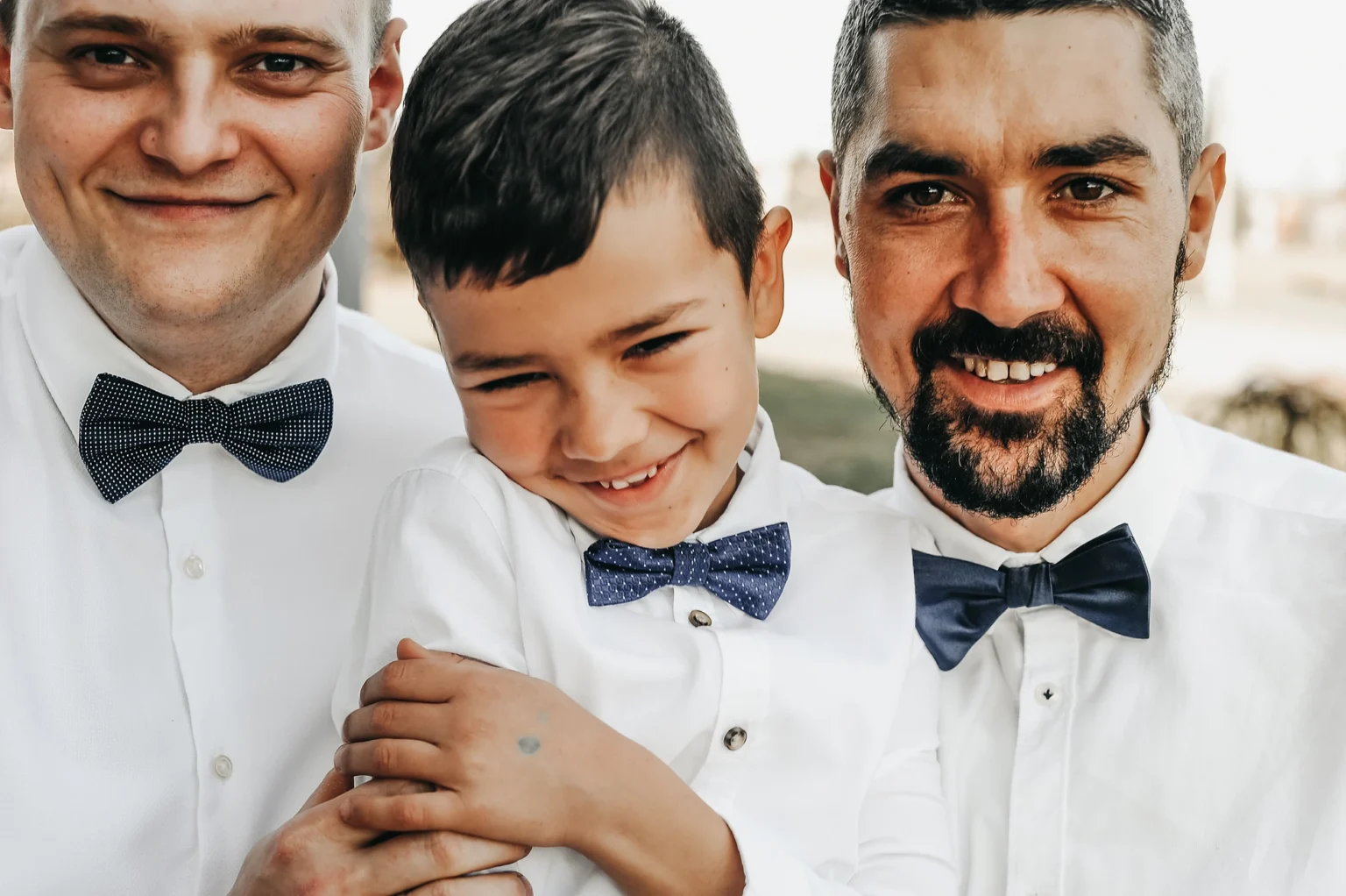 Child, best man, and dad posing together at a baptism in Vienna. The image captures the family and special guest in a joyful and memorable moment during the baptism ceremony