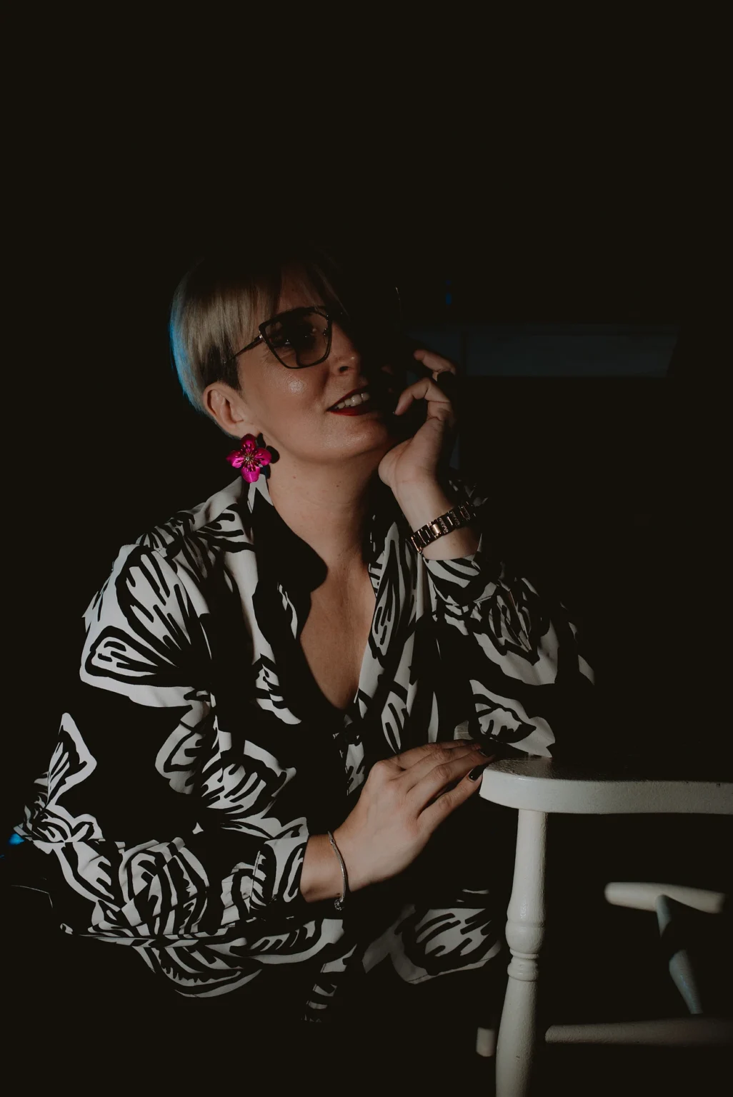 Portrait of a high school teacher taken with one studio light. The image highlights the teacher's professional appearance and demeanor in a well-lit studio setting.