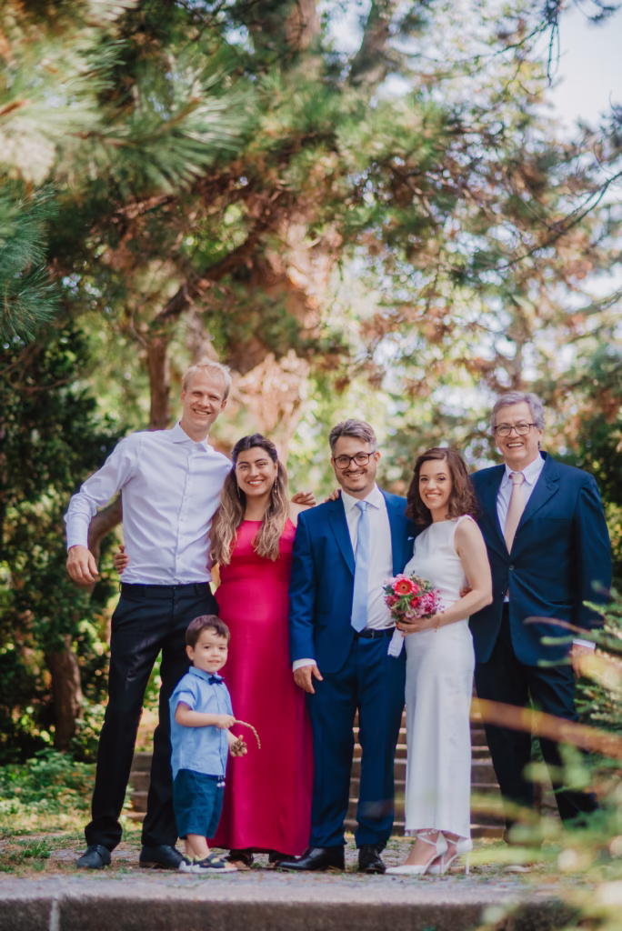 Bride and groom posing with their family during their wedding in Vienna, dressed in elegant wedding attire. Captured by wedding photographer Vinko Jovanovac, highlighting the importance of family in wedding photography.