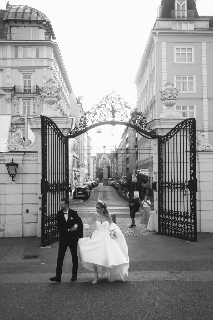 Belvedere Palace at sunset, its reflecting pools mirroring the grandeur of its architecture, with a bride and groom elegantly posed in front, radiating timeless sophistication.