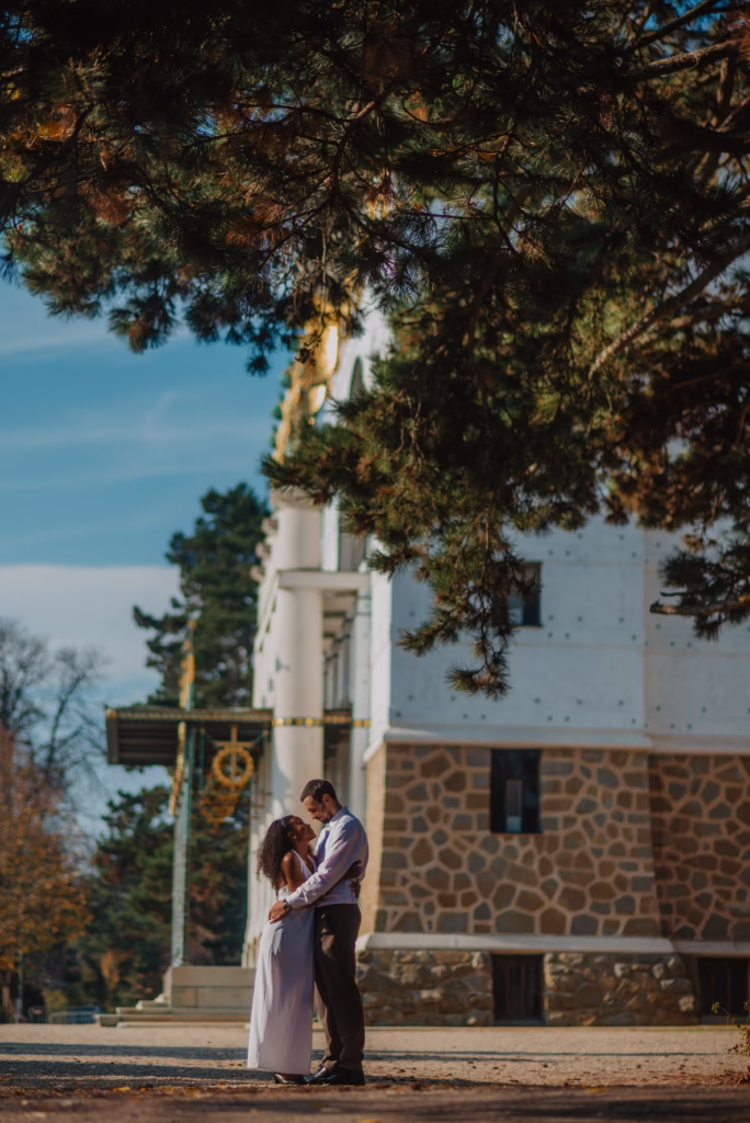 Bride and groom in an intimate embrace, softly illuminated by golden light, framed against an elegant European backdrop, exuding romance and sophistication.Would you like a more editorial-style version for an ultra-luxury feel?